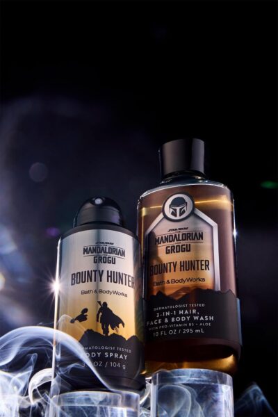 Two Bath Body Works Mandalorian Bounty Hunter bottles hairfacebody wash and spray against a dark smoky background