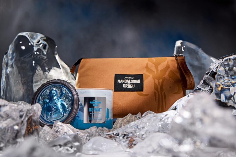 Mandalorian themed brown bag with Grogu emblem resting in icy surroundings with a blue Star Wars candle nearby