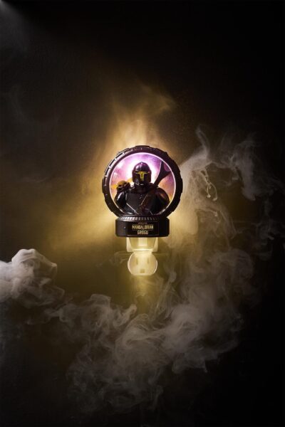 Mandalorian and Grogu figurine inside a glowing circular display with swirling smoke on a dark background