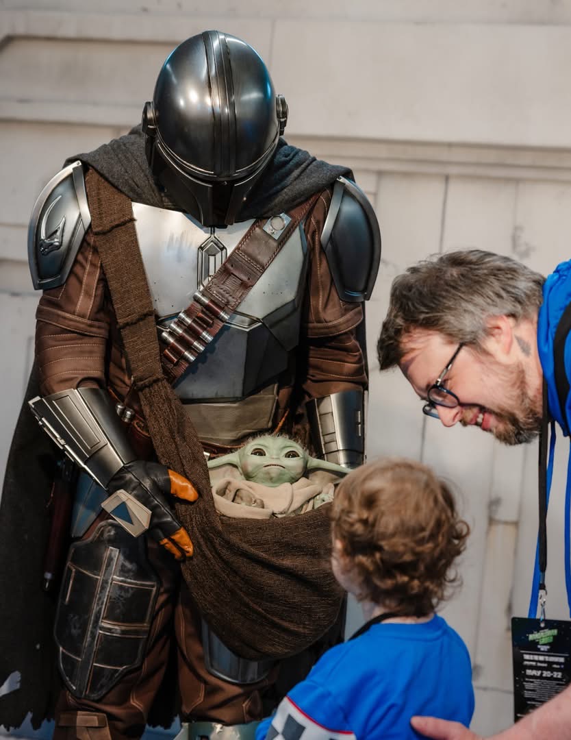 Mando and Grogu Greeting a Child