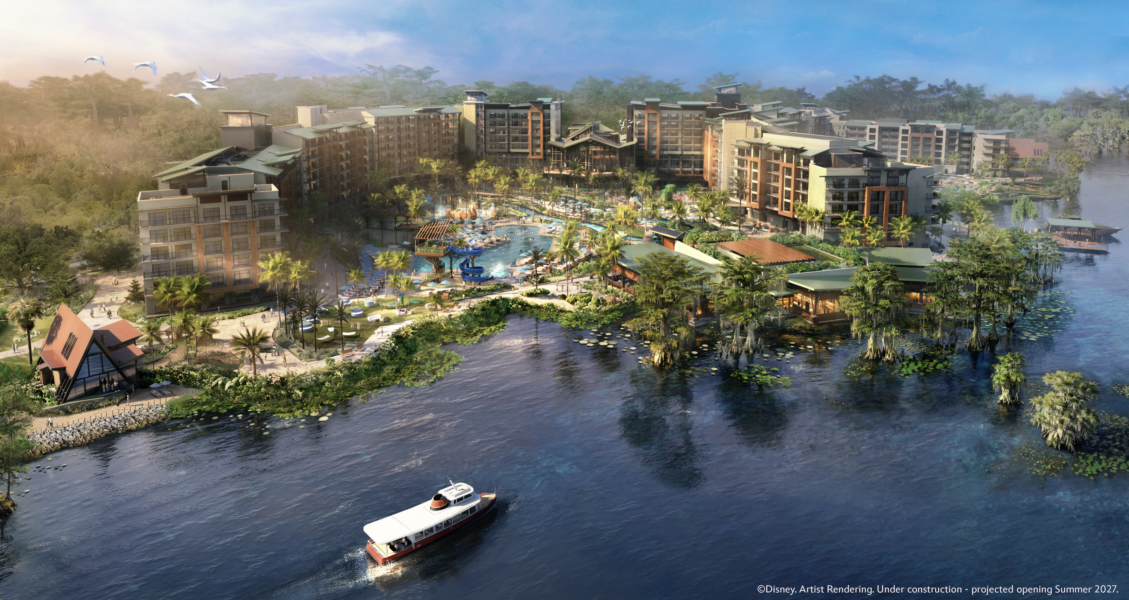 Large resort complex with palm trees a central pool area multiple buildings and a boat on a surrounding lagoon
