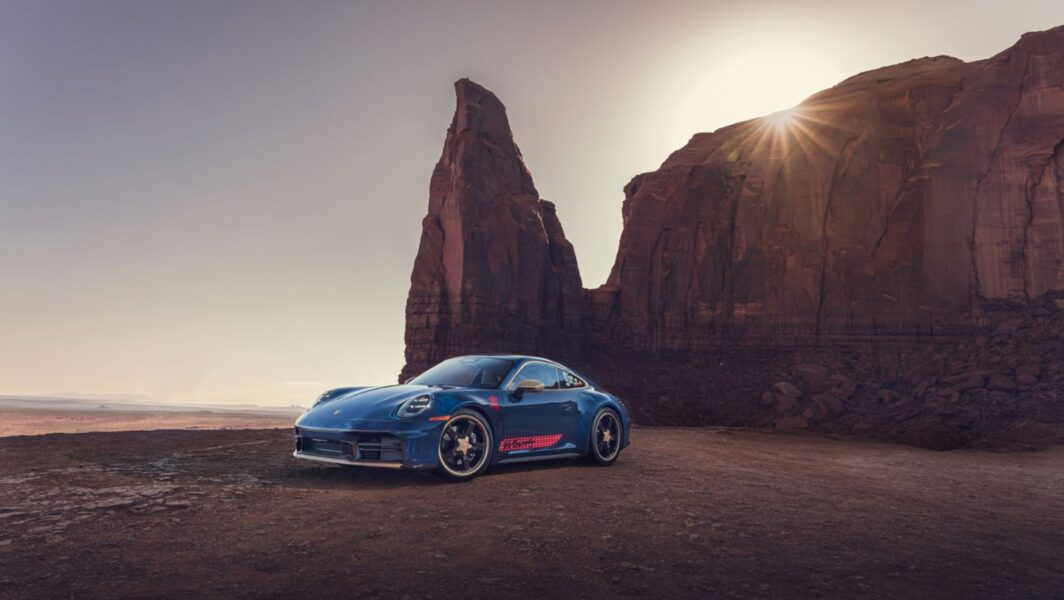 PORSCHETOYSTORY5WOODY001DSC05973 | The Main Street Mouse Blue Sports Car Parked on Cracked Desert Ground with Towering Red Rock Formations and a Setting Sun Behind the Cliffs